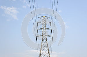 High-voltage tower on blue sky background.