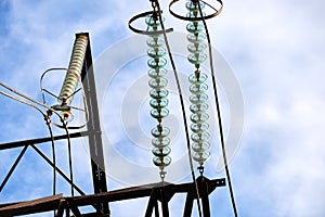 High voltage tower with electric power lines divided by safe guard bushing transfening safely electrical energy through