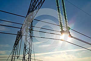 High voltage tower with electric power lines divided by safe guard bushing transfening safely electrical energy through