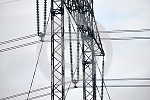 High voltage tower with electric power lines divided by safe guard bushing transfening safely electrical energy through