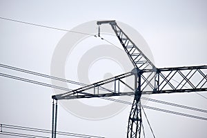 High voltage tower with electric power lines divided by safe guard bushing transfening safely electrical energy through