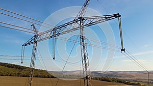 High voltage tower with electric power lines transfening electrical energy through cable wires