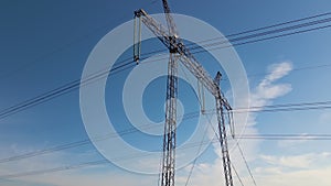 High voltage tower with electric power lines transfening electrical energy through cable wires