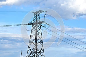 High voltage tower with electric power lines transfening electrical energy through cable wires