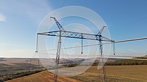 High voltage tower with electric power lines transfening electrical energy through cable wires