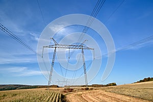 High voltage tower with electric power lines transfening electrical energy through cable wires