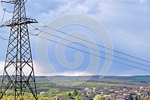 High voltage tower with electric power lines transfening electrical energy through cable wires