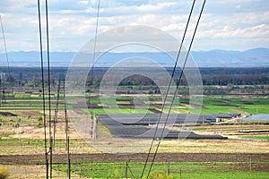 High voltage tower with electric power lines transfening electrical energy through cable wires