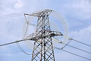 High voltage tower with electric power lines transfening electrical energy through cable wires