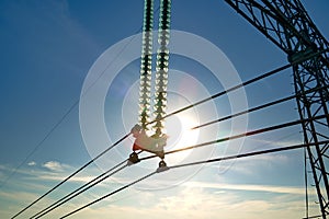 High voltage tower with electric power lines transfening electrical energy through cable wires