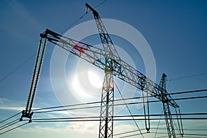 High voltage tower with electric power lines transfening electrical energy through cable wires