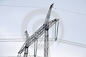 High voltage tower with electric power lines transfening electrical energy through cable wires