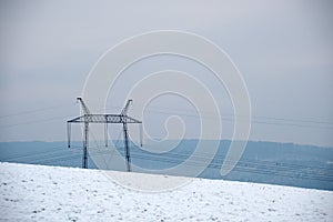 High voltage tower with electric power lines transfening electrical energy through cable wires
