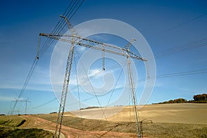 High voltage tower with electric power lines transfening electrical energy through cable wires