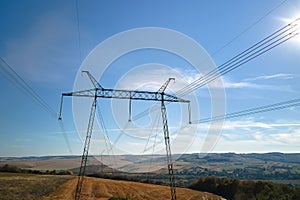 High voltage tower with electric power lines transfening electrical energy through cable wires