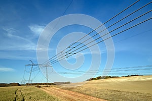 High voltage tower with electric power lines transfening electrical energy through cable wires