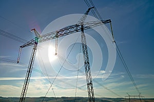 High voltage tower with electric power lines transfening electrical energy through cable wires