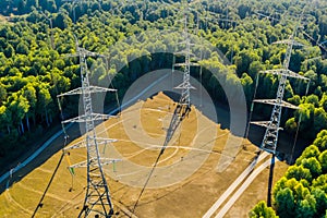 High voltage tower. High voltage. Electricity transmission power lines at sunset (high voltage pylon). Aerial view