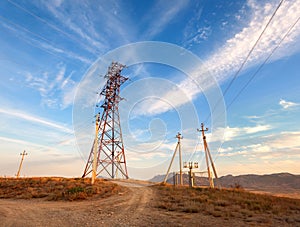 High voltage tower in mountains at sunset. Electricity pylon system