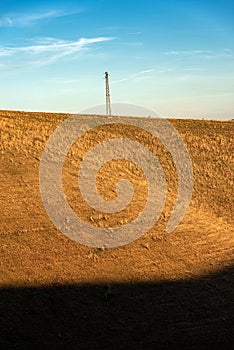 High voltage tower and power line in mountain