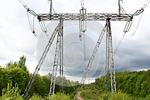 High voltage towers over storm-cloud