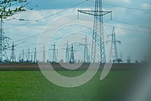 High voltage towers with sky background. Power line support with wires for electricity transmission. High voltage grid