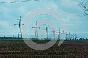 High voltage towers with sky background. Power line support with wires for electricity transmission. High voltage grid