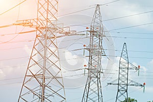 High voltage towers with sky background. Power line support with wires for electricity transmission. High voltage grid