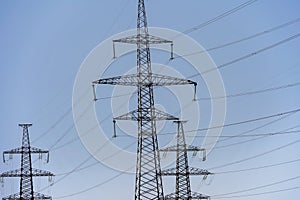 High voltage towers with sky background. Power line support with wires for electricity transmission. High voltage grid