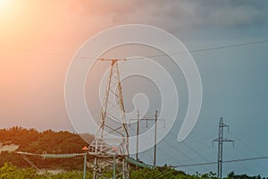 High voltage towers with sky background. Power line support with wires for electricity transmission. High voltage grid