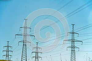 High voltage towers with sky background. Power line support with wires for electricity transmission. High voltage grid