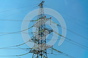 High voltage towers with sky background. Power line support with wires for electricity transmission. High voltage grid