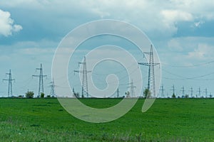 High voltage towers with sky background. Power line support with wires for electricity transmission. High voltage grid