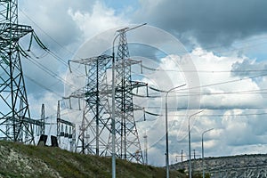 High voltage towers with sky background. Power line support with wires for electricity transmission. High voltage grid