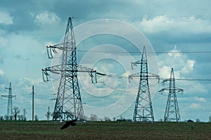 High voltage towers with sky background. Power line support with wires for electricity transmission. High voltage grid