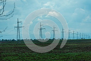 High voltage towers with sky background. Power line support with wires for electricity transmission. High voltage grid