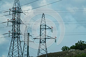 High voltage towers with sky background. Power line support with wires for electricity transmission. High voltage grid