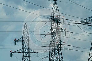 High voltage towers with sky background. Power line support with wires for electricity transmission. High voltage grid