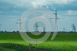 High voltage towers with sky background. Power line support with wires for electricity transmission. High voltage grid