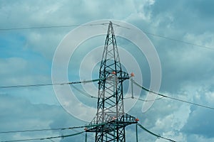 High voltage towers with sky background. Power line support with wires for electricity transmission. High voltage grid