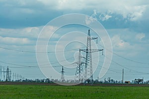 High voltage towers with sky background. Power line support with wires for electricity transmission. High voltage grid