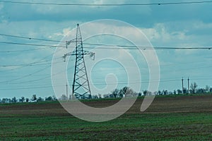 High voltage towers with sky background. Power line support with wires for electricity transmission. High voltage grid