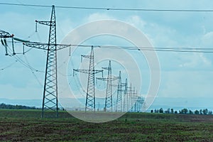 High voltage towers with sky background. Power line support with wires for electricity transmission. High voltage grid