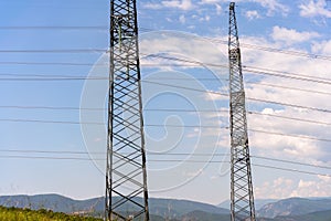 High voltage towers with sky background. Power line support with wires for electricity transmission. High voltage grid