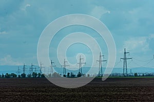 High voltage towers with sky background. Power line support with wires for electricity transmission. High voltage grid