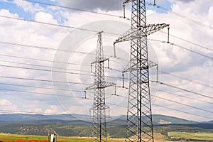 High voltage towers with sky background. Power line support with wires for electricity transmission. High voltage grid