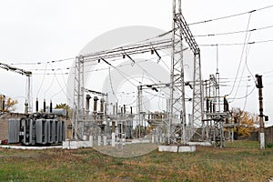 High voltage transformer at an electrical substation of the city power grid. Power wires with high voltage