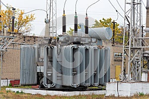 High voltage transformer at an electrical substation of the city power grid. Power wires with high voltage