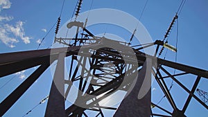 High-voltage transmission line. High voltage power pylons against blue sky. High voltage power line.