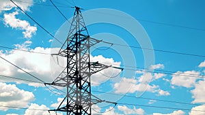 High-voltage transmission line. High voltage power pylons against blue sky. High voltage power line.